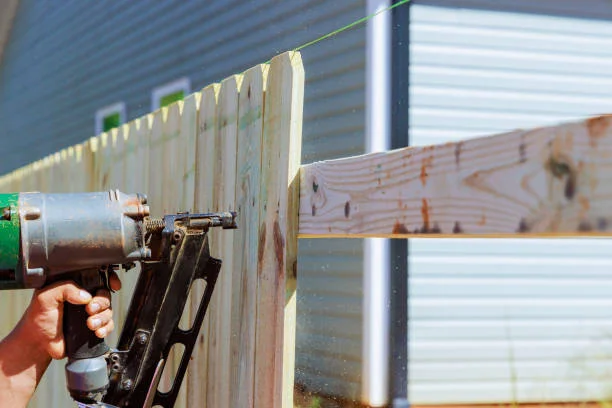 building and repairing a wooden fence with a nail gun