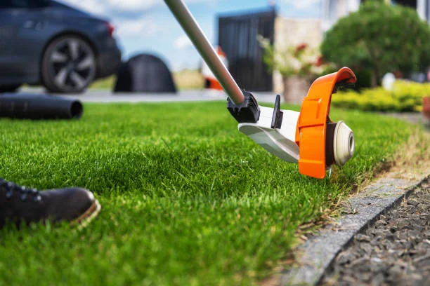 weed wacker edging a lawn
